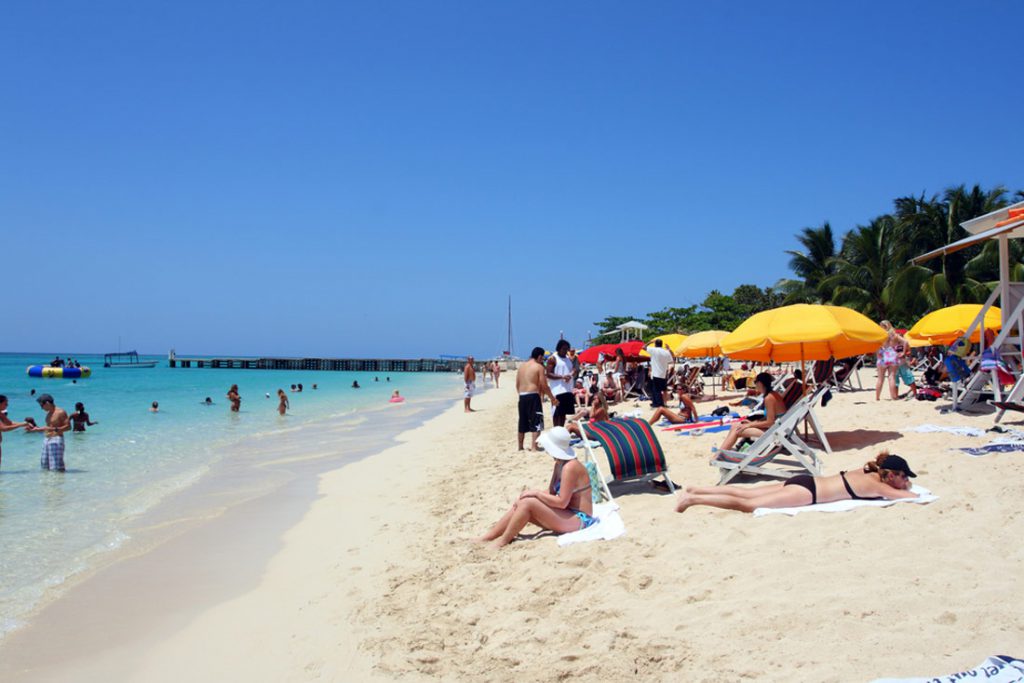Sunbathers on beach Jamaica