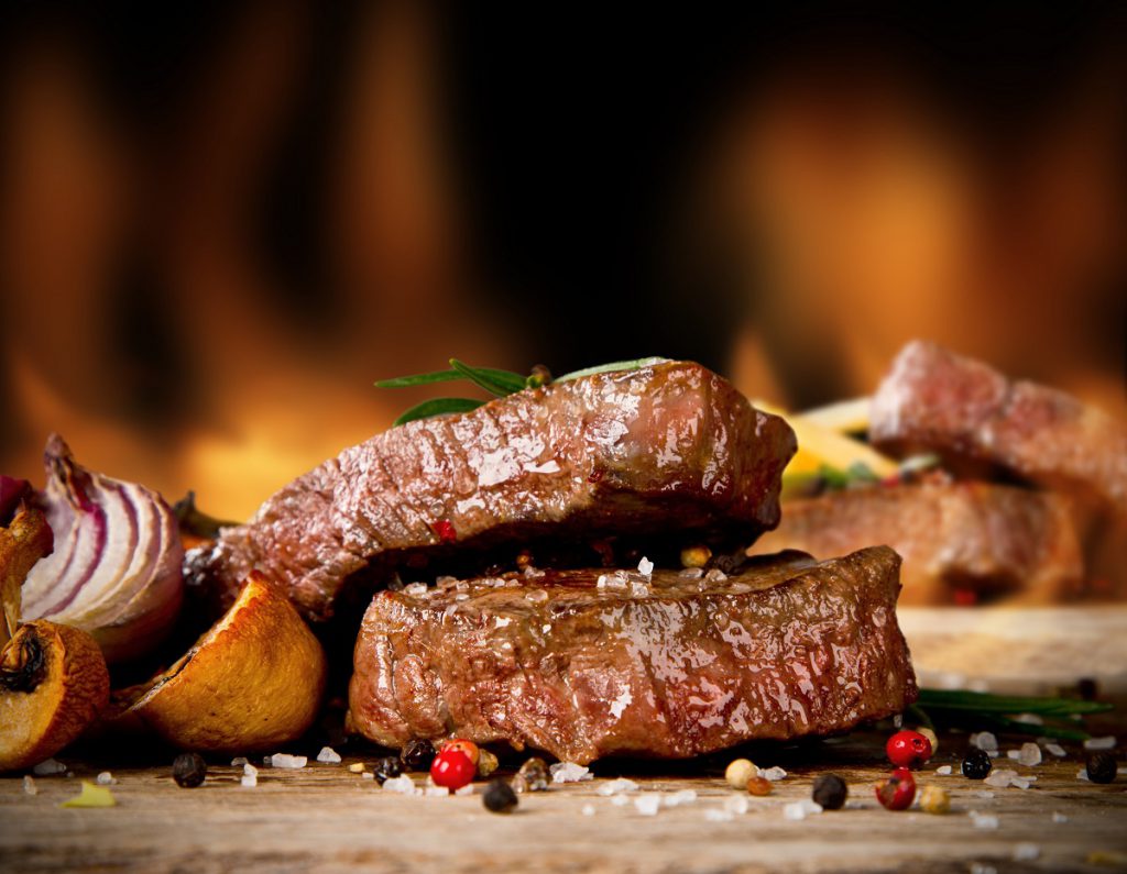 Delicious beef steaks on grill Fare Buzz